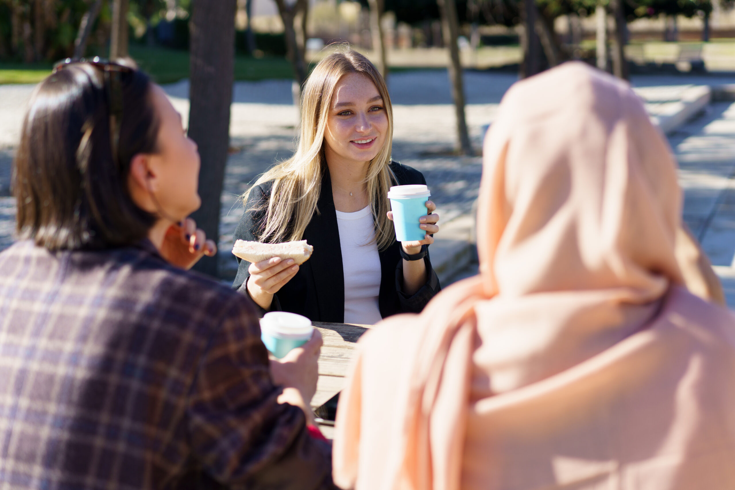 three-diverse-girls-having-coffee-break-and-chatti-2023-11-27-05-09-41-utc-scaled_main