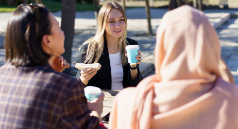 three-diverse-girls-having-coffee-break-and-chatti-2023-11-27-05-09-41-utc-scaled_main