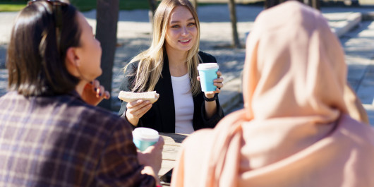 three-diverse-girls-having-coffee-break-and-chatti-2023-11-27-05-09-41-utc-scaled_main